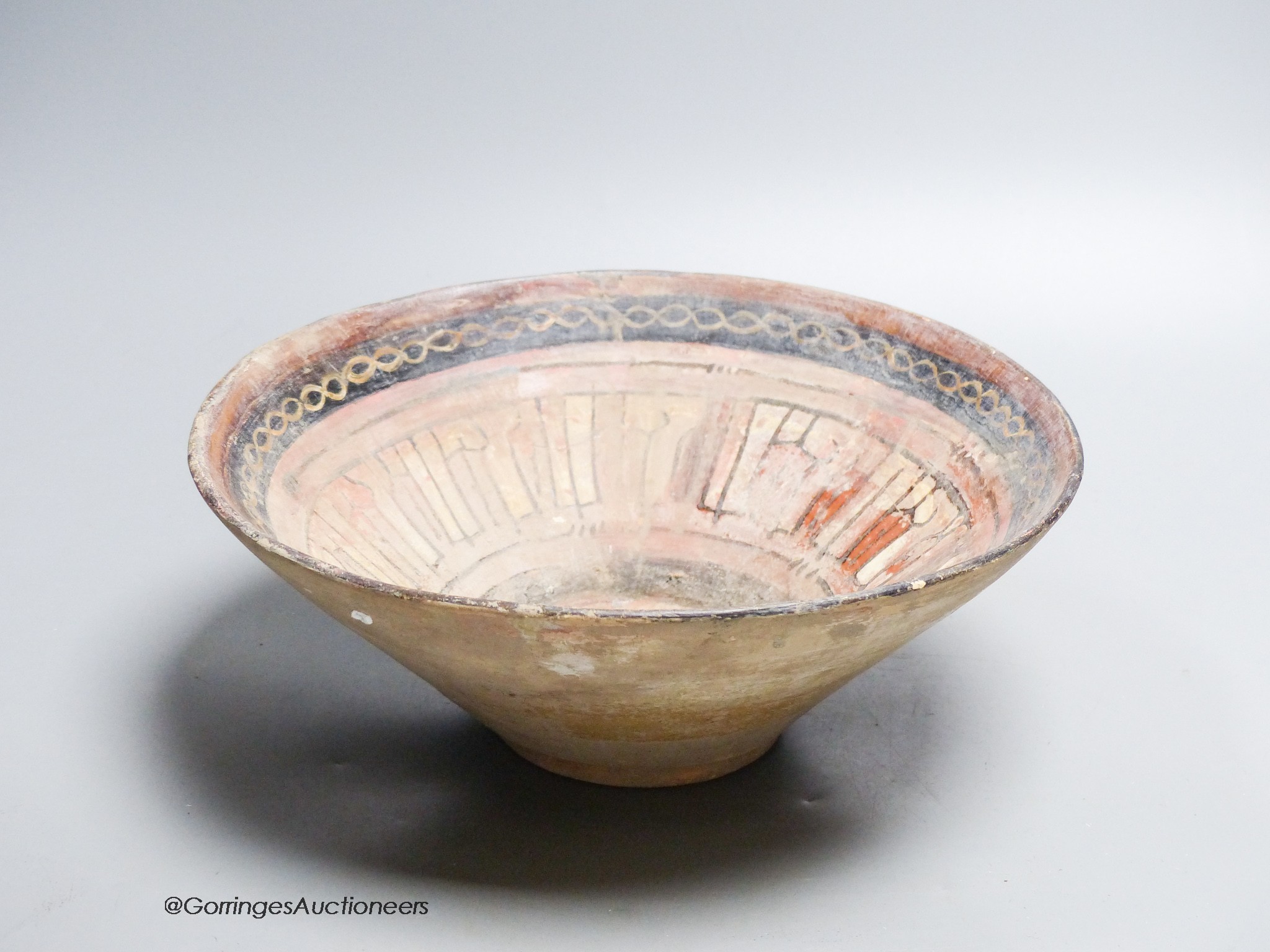 An Islamic bowl with kufic script, diameter 24cm